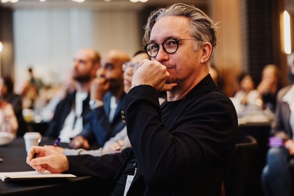 Matt Kurowski listens intently during a Design Leadership 2025 session, surrounded by peers immersed in thoughtful discussion and note-taking.