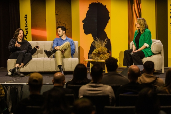 Tarra van Amerongen, Matthew Blode, and Trudi Boatwright speaking on a panel at Product Outlook 2025 in Melbourne, seated on stage with a live audience.